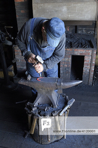 Blacksmith working hot metal to make a horseshoe