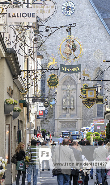Medieval iron guild or craft signs hanging over shops in the Getreidegasse  Salzburg  Austria  Europe