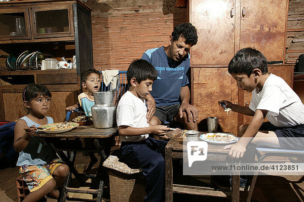 Guarani family eating  single father  in the poor area of Chacarita  Asuncion  Paraguay  South America