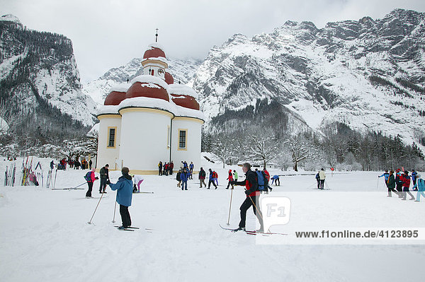 St. Bartholomew's Church at the frozen Koenigssee  cross-country skiers  Berchtesgadener Land  Upper Bavaria  Germany