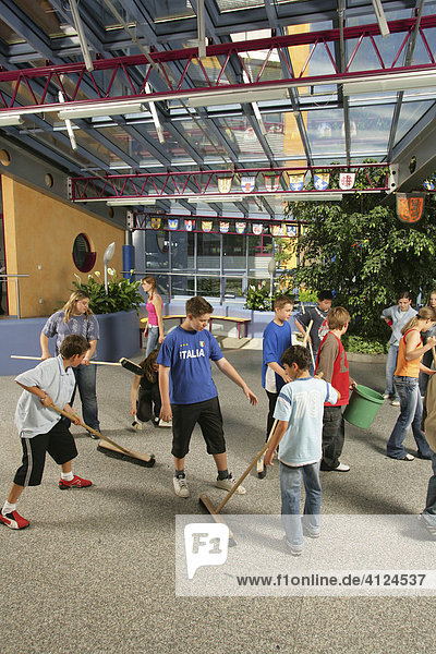 Personal responsibility  schoolchildren cleaning break hall of new school  Waldkraiburg  Upper Bavaria  Bavaria  Germany