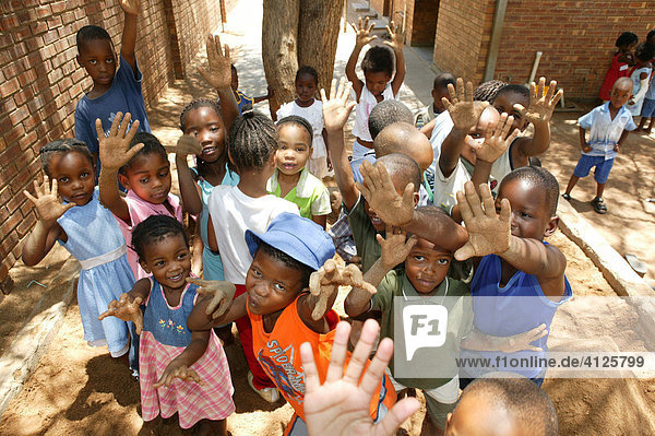 Children showing their sandy hands at a kindergarten  Gaborone  Botswana  Africa
