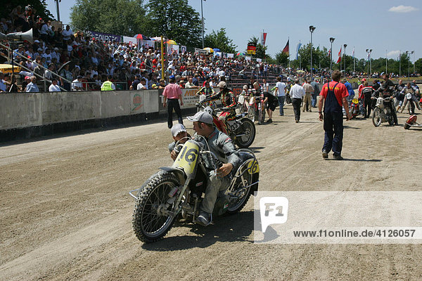 Sidecar motorcycles at the starting line  international motorcycle race on a dirt track speedway in Muehldorf am Inn  Upper Bavaria  Bavaria  Germany  Europe
