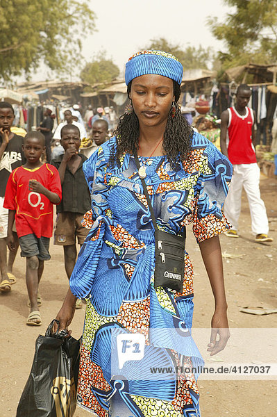 Woman walking through a market  Garoua  Cameroon  Africa