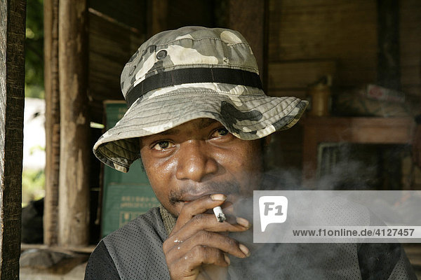 Rauchender junger Mann  Dorf Mindre  Papua Neuguinea  Melanesien  Kontinent Australien