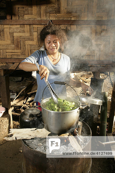 Woman preparing a meal  Biliau  Papua New Guinea  Melanesia