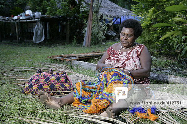 Frau knüpft einen Bilum (Typische Tasche in PNG)  Biliau  Papua Neuguinea  Melanesien  Kontinent Australien