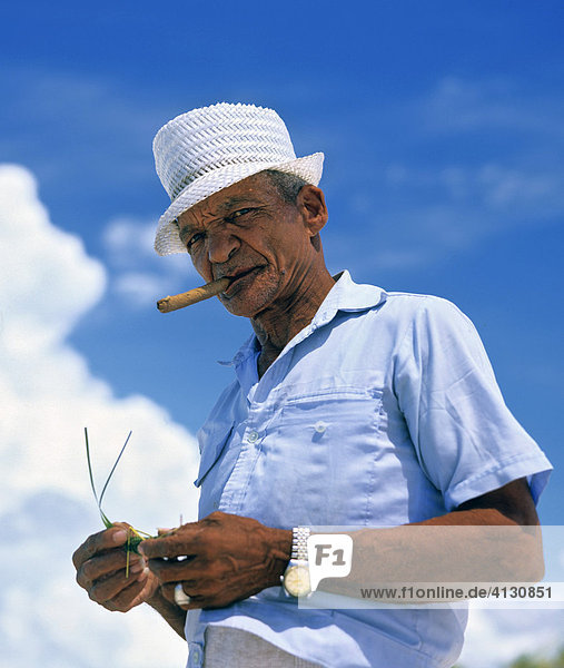 Man smoking a Cuban cigar  clouds  Cuba