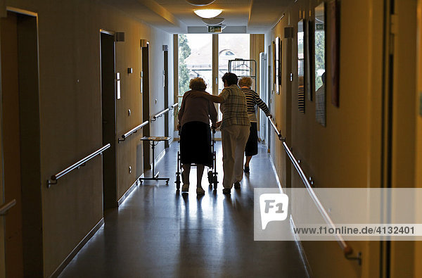 Nurse caring for old woman in a retirement home