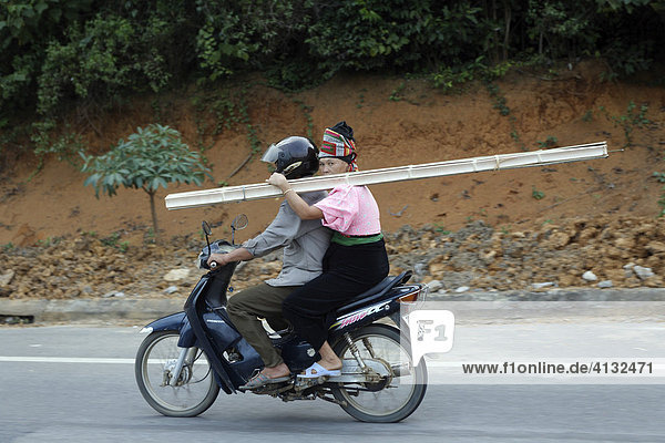 Moped riders transporting curtain rail  Son La Province  Vietnam  Asia