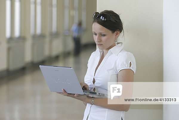 Young woman at university with a laptop