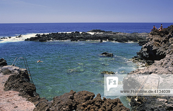 Children at natural swimming pool of Tacaron  El Hierro  Canary Islands  Spain
