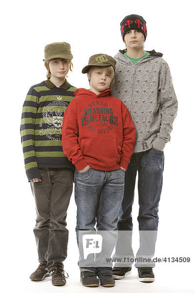 Three boys  10  12 and 13 years old  wearing caps  hats