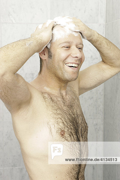 Hairy man showering  washing his hair  laughing