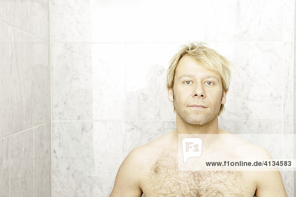 Blonde man in the shower