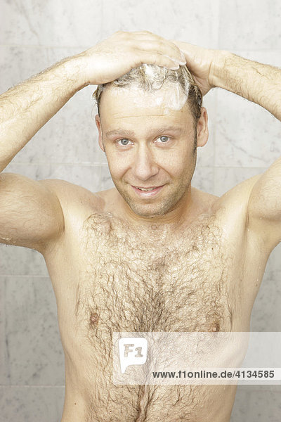 Blonde man showering