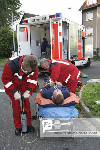 DEU Germany : Rescue paramedics first aid after an accident with a man injured at his leg. ambulance fire service. Training situation. |