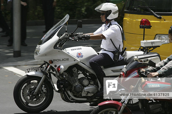 SGP  Singapore: Police officer on motorbike  Orchard Road. |