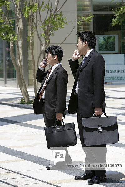 Asian businessmen with mobile phones  Tokyo  Japan