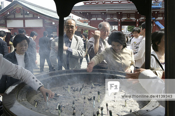 Japan  Tokio: Asakusa-Kannon-Tempel Bezirk. Weihrauchbrunnen  Gläubige reiben sich mit dem Rauch ein um z.B. schmerzende Stellen zu lindern oder sich zu verschönern.