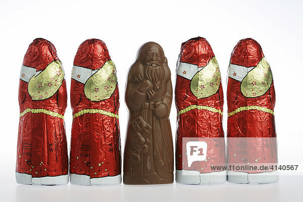 Chocolate Santas in a row  one unwrapped