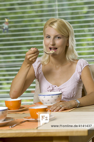 Young woman having breakfast