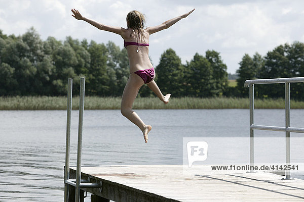 14 year old girl jumping into a lake