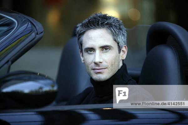 Man in black convertible