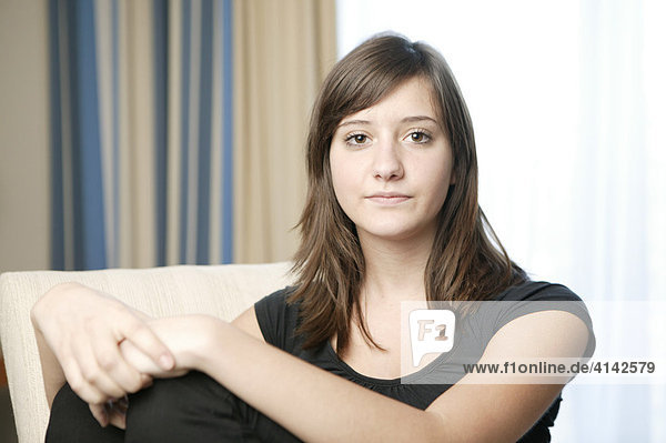 Girl sitting on a sofa  portrait