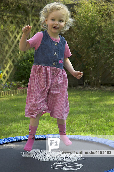 Little girl jumping on a trampoline