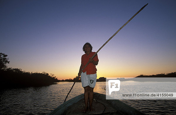 Woman standing on the bow of a vessel crossing the lagoon to Mexcaltitan Island  Nayarit  Mexico