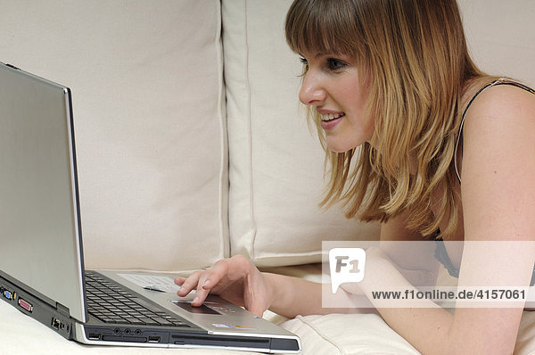 Woman on a couch with laptop