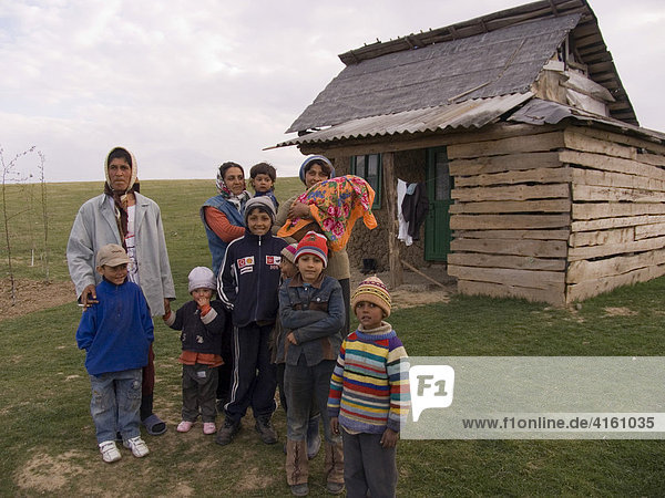 A family in front of their dwelling  Gulia  Romania