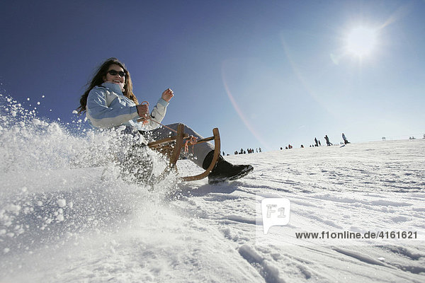 Girl is sledding  Hoherodskopf  Hesse  Germany
