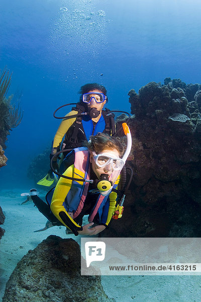 Mother and daughter scuba diving  Roatan  Honduras  Caribbean