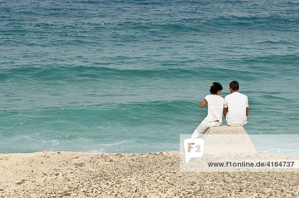 Couple looking out on the sea  Fuerteventura  Canary Islands  Spain
