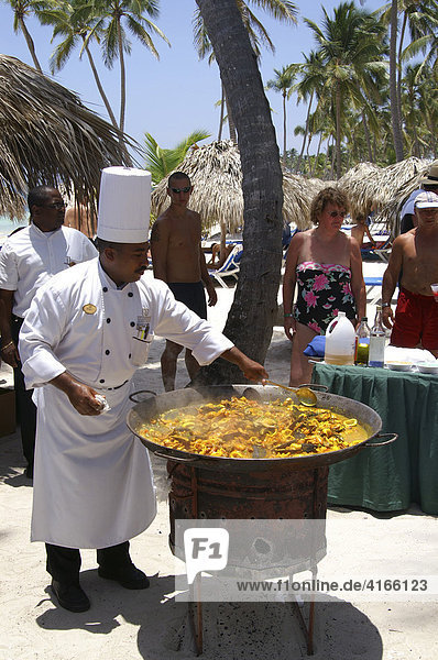 Cook preparing paella on the beach in Punta Cana  Dominican Republic  Caribbean  Americas