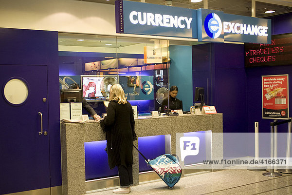 Young woman changing money at a currency exchange counter  Frankfurt International Airport  Hesse  Germany