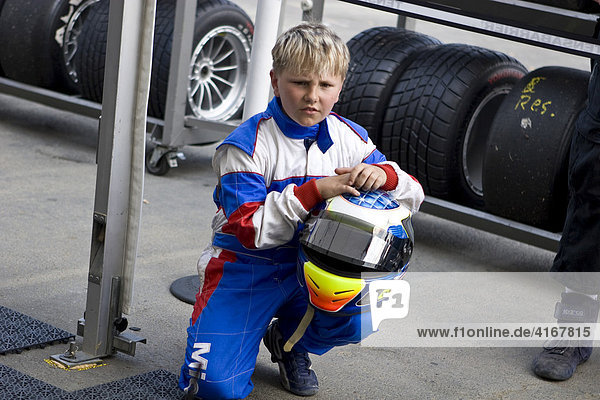 Boy in front of a Formula 3 team tent  24-hour race at the Nuerburgring racetrack in Nuerburg  Adenau  Rhineland-Palatinate  Germany