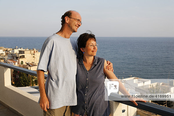 Couple at balcony of apartment Big Blue  Mirtos  Southern Crete  Greece