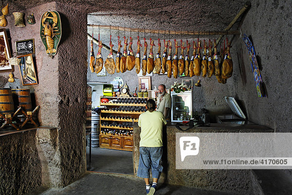 Cave bar with ham  Cuevas Bermejas in Barranco de Guayadeque  Gran Canaria  Spain