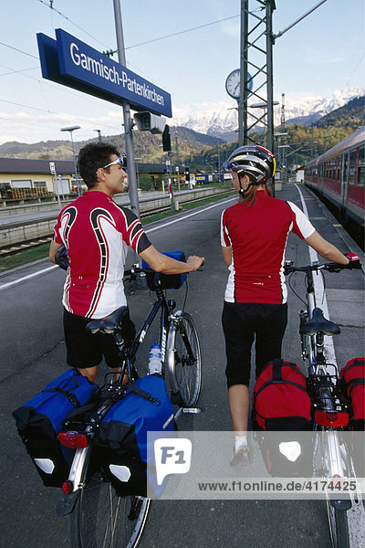Bikers wait for a train  Garmisch-Partenkirchen  Bavaria  Germany