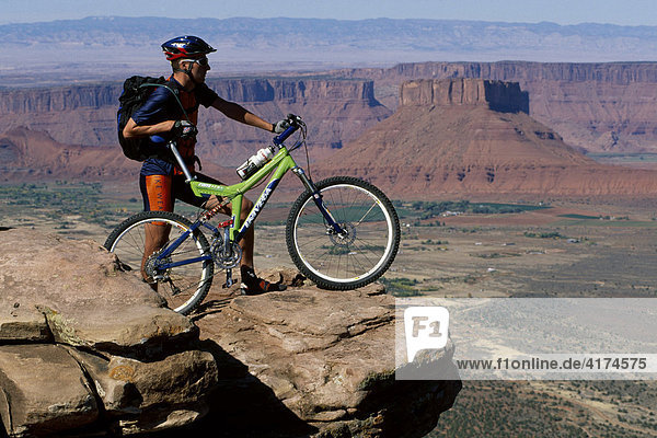 Mountain biker on a rock  Moab  Utah  USA