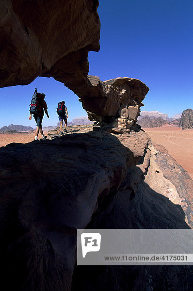 Trekking  stone arch  Wadi Rum  Jordan  Asia