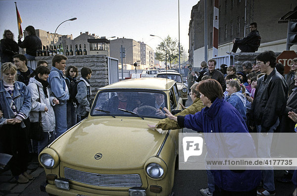Fall of the Berlin Wall: at the border crossing Chausseestrasse cars from East Berlin are greeted  Berlin  Germany