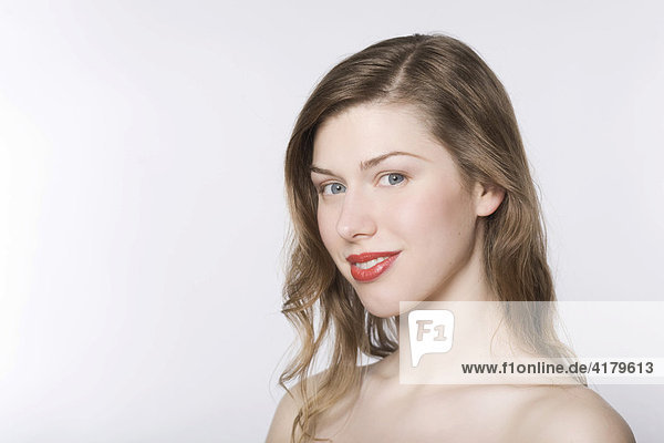 Portrait of a young woman wearing red lipstick