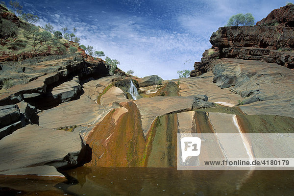 Colourful waterfall Hamersley Gorge Karijini National Park Western Australia Australia Oceania