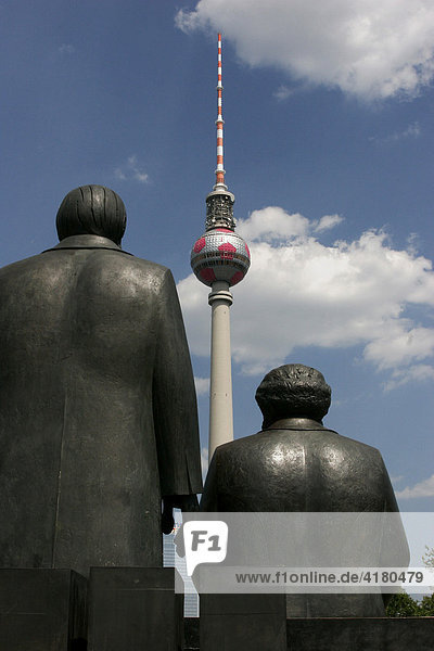 Communists Marx and Engels in front of the TV tower in the german capital Berlin Germany
