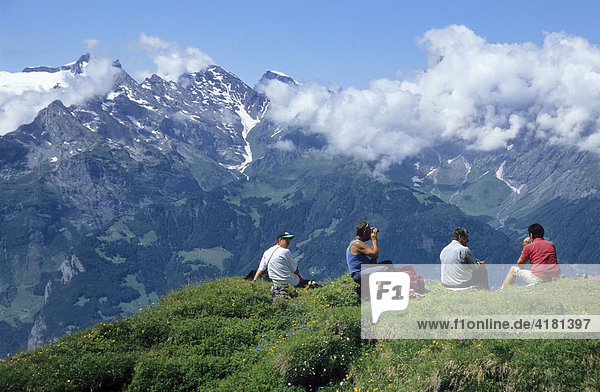 Hikers having a rest  enjoying the mountain scenery  Chinzigpass (Chinzig Pass)  Swiss Alps  Switzerland  Europe