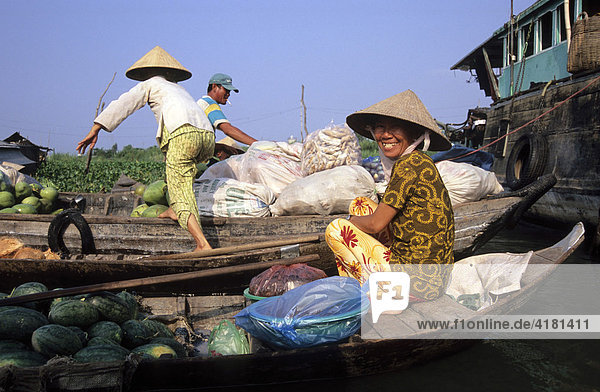 Laughing woman in a boat at the floating market in Long Xuyen  Mekong Delta  Vietnam  Asia